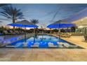 Inviting pool area with floating loungers, umbrellas, and plenty of lounge space at 6229 E Gold Dust Ave, Paradise Valley, AZ 85253