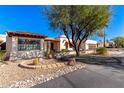 Charming home exterior with desert landscaping and large tree at 26223 N Bravo Ln, Rio Verde, AZ 85263