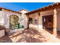 Welcoming front entry with tile flooring and ornate wooden door at 26223 N Bravo Ln, Rio Verde, AZ 85263