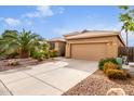 House exterior with a two-car garage and mature landscaping at 30636 N Royal Oak Way, San Tan Valley, AZ 85143