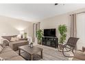 Bright living room featuring ample seating and a fireplace at 30636 N Royal Oak Way, San Tan Valley, AZ 85143