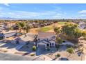 Aerial view of two-story house with pool, situated on a golf course community at 22821 S 212Th St, Queen Creek, AZ 85142