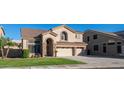 Two-story house with a three-car garage and a well-manicured lawn at 25667 N 68Th Ln, Peoria, AZ 85383