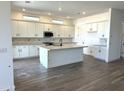 Spacious kitchen with an island, stainless steel appliances, and lots of cabinet storage at 43513 N Wollemi St, Queen Creek, AZ 85140