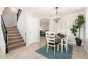 Charming dining area with tile floors, a stylish chandelier, and staircase access, great for Gathering meals at 4660 E Torrey Pines Ln, Chandler, AZ 85249