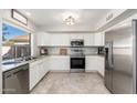 Bright kitchen featuring stainless steel appliances, granite countertops, and white cabinetry, ideal for cooking at 4660 E Torrey Pines Ln, Chandler, AZ 85249