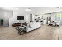 Bright, stylish living room featuring a modern white sofa, open layout, and hardwood-style flooring at 735 E Calavar Rd, Phoenix, AZ 85022