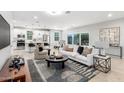 Bright, open living space featuring modern decor, a sleek white sofa, and an open kitchen concept at 735 E Calavar Rd, Phoenix, AZ 85022