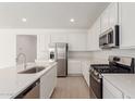 Modern kitchen featuring stainless steel appliances, quartz countertops, and white cabinetry at 12337 W Marguerite Ave, Avondale, AZ 85323