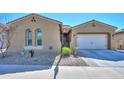 Inviting single-story home with a two-car garage, arched windows, and a low-maintenance gravel yard at 18169 W Cactus Flower W Dr, Goodyear, AZ 85338