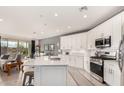 Open concept kitchen with island, stainless steel appliances, and views to the backyard at 2837 W Minton St, Phoenix, AZ 85041