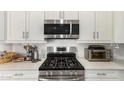 Stainless steel appliances and white cabinets highlight this kitchen at 2837 W Minton St, Phoenix, AZ 85041