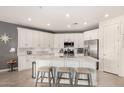 Spacious kitchen featuring white cabinets, a large island, and stainless steel appliances at 2837 W Minton St, Phoenix, AZ 85041