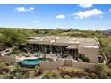 Aerial view showcasing a beautiful home, pool, and desert landscape at 9784 E Miramonte Dr, Scottsdale, AZ 85262