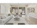 Bright, open living area featuring travertine floors, neutral decor, and sliding doors to the backyard at 8146 E Wingspan Way, Scottsdale, AZ 85255