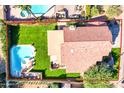 House with pool and spa, grassy backyard, and desert landscaping at 8885 E Voltaire Dr, Scottsdale, AZ 85260