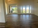 Bright and spacious living area with wood-look tile floors and access to backyard at 12646 N 17Th Pl, Phoenix, AZ 85022