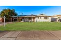 Charming home featuring a lush green lawn and a fountain, complete with modern solar panels at 142 W Ivanhoe Pl, Chandler, AZ 85225