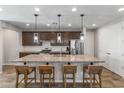 Spacious kitchen boasts a large island with seating and granite counters, perfect for entertaining at 22459 E Marsh Rd, Queen Creek, AZ 85142