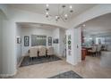 Elegant dining area features a modern chandelier, seating for six, and views of the kitchen at 15312 S 181St Dr, Goodyear, AZ 85338