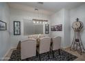 Cozy dining space with a rustic table, upholstered chairs, and a decorative area rug at 15312 S 181St Dr, Goodyear, AZ 85338