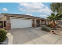 One-story house with a white garage door and stone accents at 17475 W Caribbean Ln, Surprise, AZ 85388
