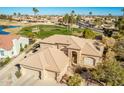 Two-story home with tile roof and a golf course view in a luxury community at 9048 E Cedar Waxwing Dr, Sun Lakes, AZ 85248
