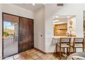 Entryway with wood door and kitchen bar view at 9250 E Whitethorn Cir, Scottsdale, AZ 85266