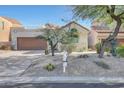 Single-story home with desert landscaping and two-car garage at 23635 N 75Th Pl, Scottsdale, AZ 85255