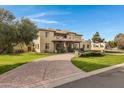 Impressive two-story home with a large driveway and nicely landscaped lawn at 2697 E Via Del Arboles --, Gilbert, AZ 85298