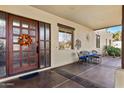 Inviting front porch with a wooden door and comfortable seating area at 2697 E Via Del Arboles --, Gilbert, AZ 85298