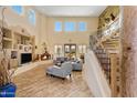 Open living room with high ceilings, a fireplace, and large windows at 2697 E Via Del Arboles --, Gilbert, AZ 85298