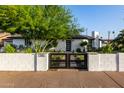 Exterior view of updated home with fresh landscape and updated black fence at 1345 W Edgemont Ave, Phoenix, AZ 85007