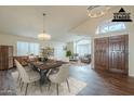An open-concept dining room with modern lighting and stylish furniture offers a perfect setting for Gathering gatherings at 14426 W Morning Star Trl, Surprise, AZ 85374