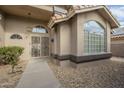 Front entry with decorative iron door and walkway at 14426 W Morning Star Trl, Surprise, AZ 85374