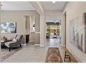 Bright hallway leads to the living room and kitchen with neutral tones and decorative accents at 2835 E Los Gatos Dr, Phoenix, AZ 85050
