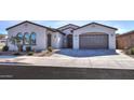 House exterior with a two-car garage and landscaping at 3919 W Hayduk Rd, Laveen, AZ 85339