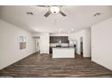 Open concept living room and kitchen with wood-look floors and lots of natural light at 659 W Pintail Dr, Casa Grande, AZ 85122