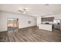 Spacious living room with wood-look floors and sliding glass doors to the backyard at 659 W Pintail Dr, Casa Grande, AZ 85122