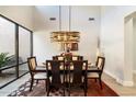 Elegant dining room with a modern chandelier and hardwood floors at 12175 E Columbine Dr, Scottsdale, AZ 85259