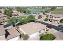 Aerial view of a single-Gathering home with tile roof and desert landscaping in a golf course community at 13613 W Cypress St, Goodyear, AZ 85395