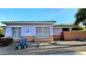 House with light purple stucco exterior and desert landscaping at 13613 W Cypress St, Goodyear, AZ 85395