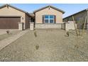 Well-maintained home with a gated front yard and low-maintenance desert landscaping at 17648 W Pierson St, Goodyear, AZ 85395