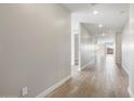 Bright hallway featuring wood-look tile floors at 17749 W Elm St, Goodyear, AZ 85395