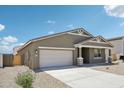 This single-story home features a two-car garage and simple desert landscaping at 47267 W Mellen Ln, Maricopa, AZ 85139