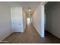 Bright hallway with tile flooring and recessed lighting leading to the main areas of the home at 47267 W Mellen Ln, Maricopa, AZ 85139