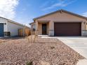Single-story home with desert landscaping, stone accents, and a two-car garage at 9120 N 174Th Ln, Waddell, AZ 85355
