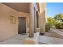 Front entrance with wood columns and a metal security door at 12438 N Saguaro Blvd # 126, Fountain Hills, AZ 85268
