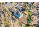 This stunning aerial view reveals a home with a sparkling pool and a meticulously landscaped backyard at 4510 N Pierce Ct, Buckeye, AZ 85396