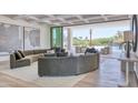 Open-concept living room with modern furnishings, leading to an outdoor pool area at 6215 N Casa Blanca Dr, Paradise Valley, AZ 85253